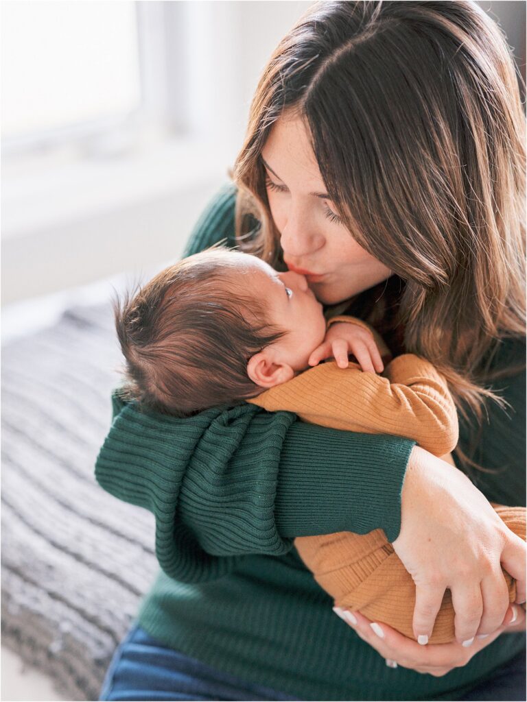 Mom giving baby kisses