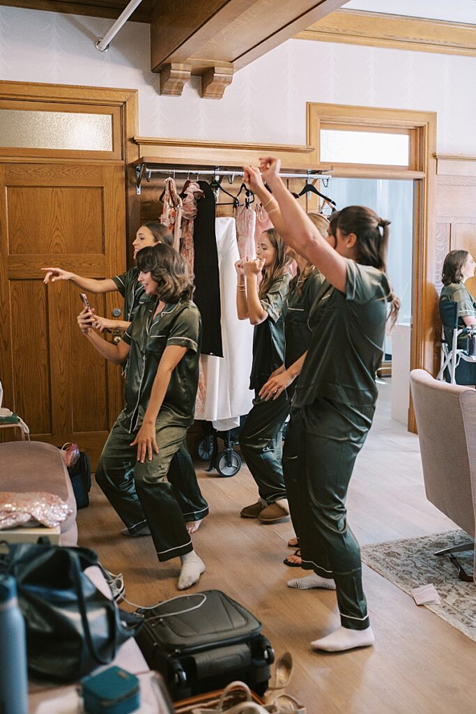 Bridesmaids dancing while getting ready