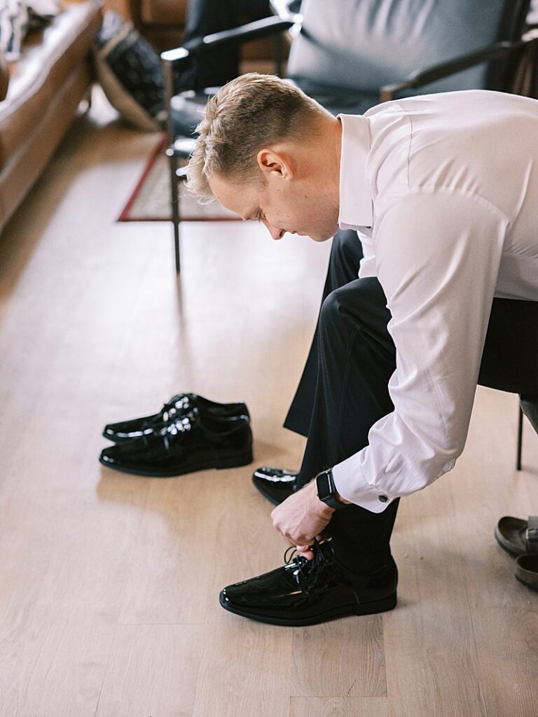 Groom putting on shoes